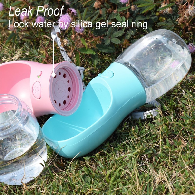 A Pink and Blue Portable Dog Water Bottle for Dogs, resting gracefully in the lush green grass.