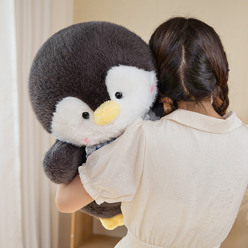 Woman hugging stuffed animal penguin plushie