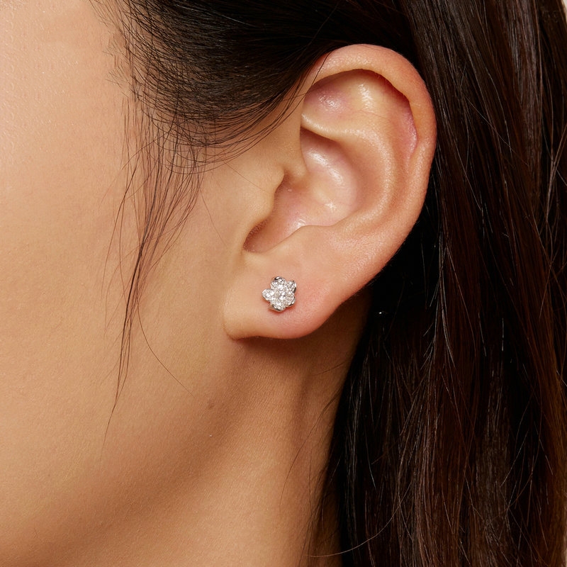 S925 Sterling Silver Flower Zircon Inlaid Stud Earrings on one ear