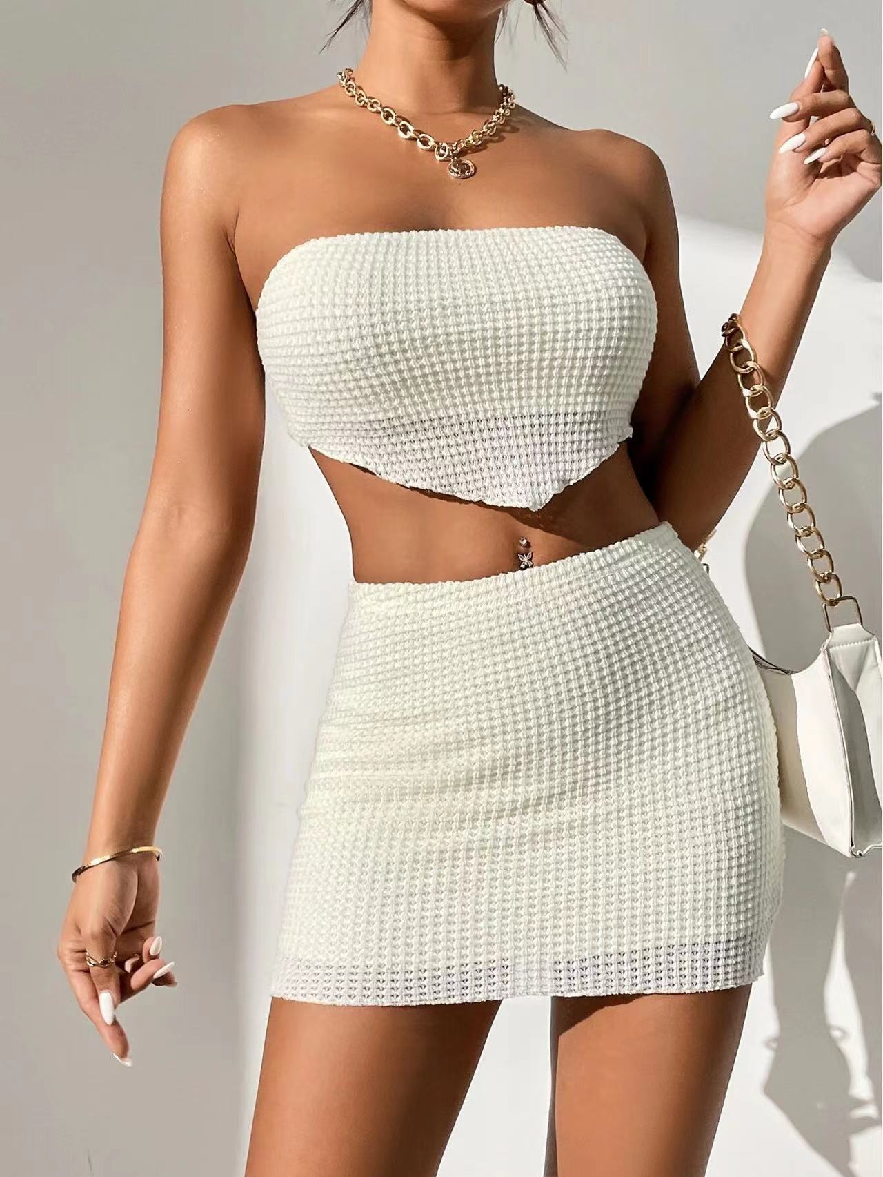 Woman showcasing the VivaraEssence Pearl Radiance Bandeau and Skirt Set in white, featuring a textured pattern.