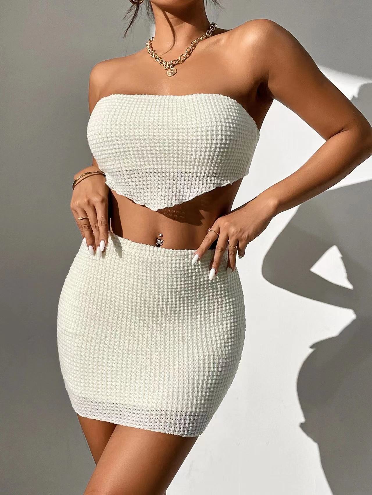 Woman showcasing the VivaraEssence Pearl Radiance Bandeau and Skirt Set in white, featuring a textured pattern.