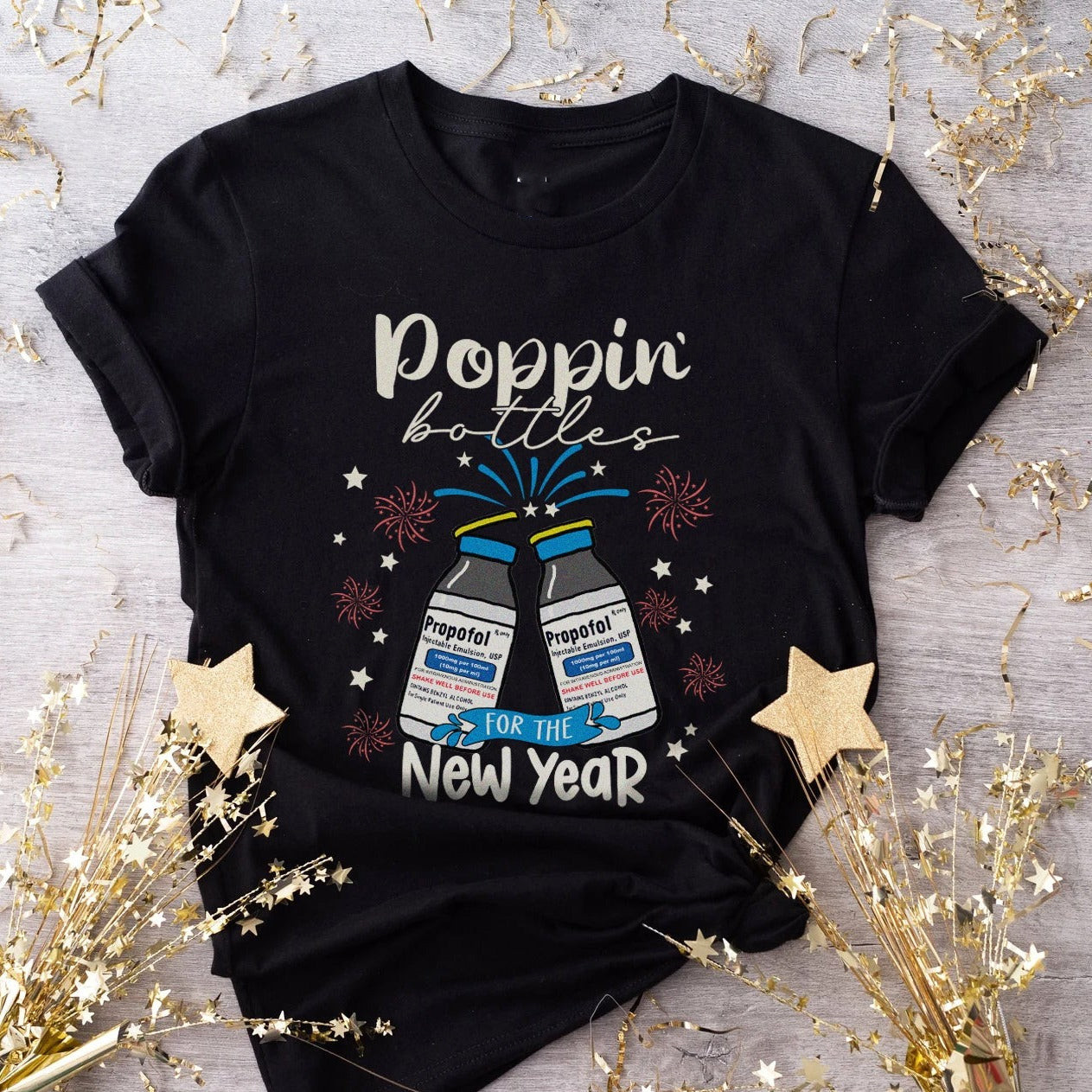 Celebrate in chic style with our Poppin Bottle New Year T-shirt in classic black. Cheers to fashion! image 1