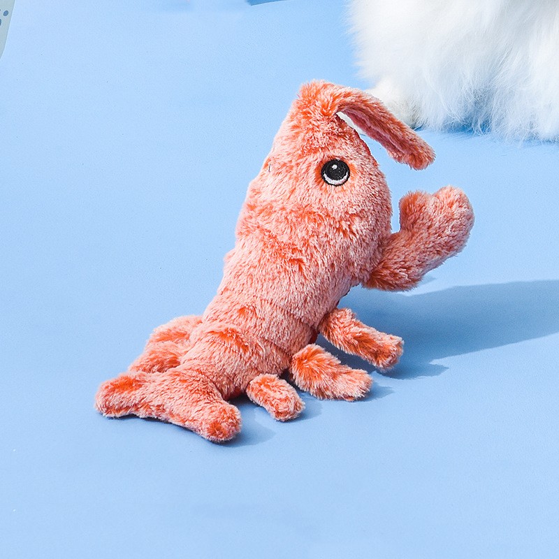 A orange jumping shrimp cat toy on a blue background.