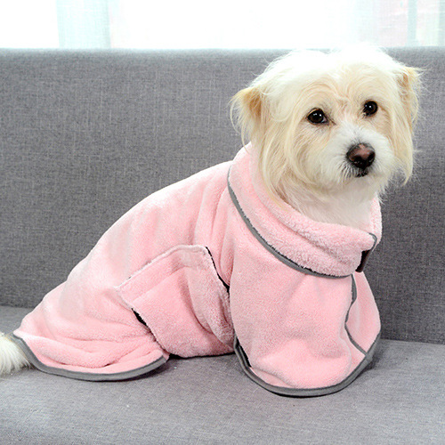 Cute pup wrapped in a pink dog bathrobe.