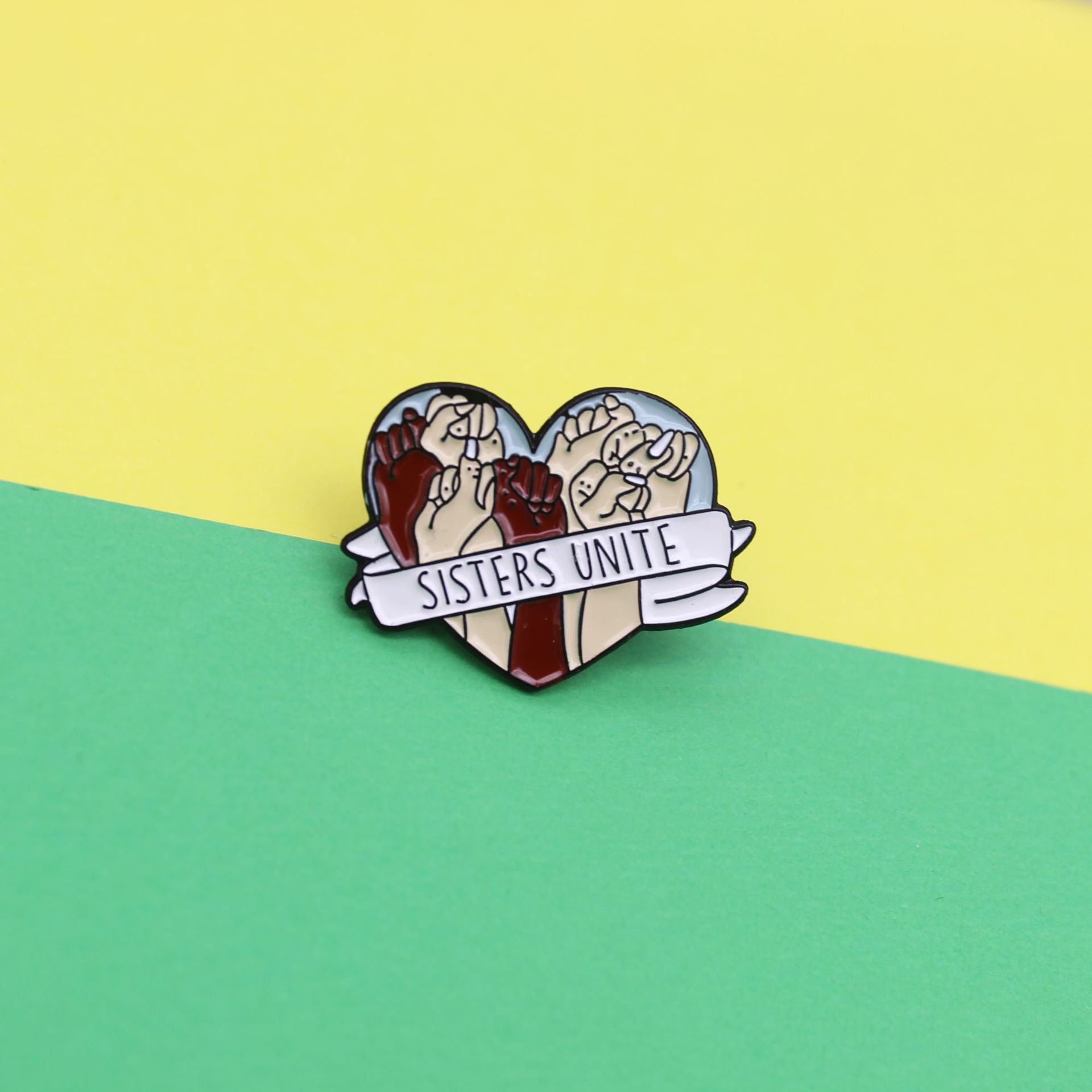 e50d4094 a978 4ffa bcdb 70bbfb8ba1b3 Heart-Shaped Ribbon Wrapped Around a Fist Brooch